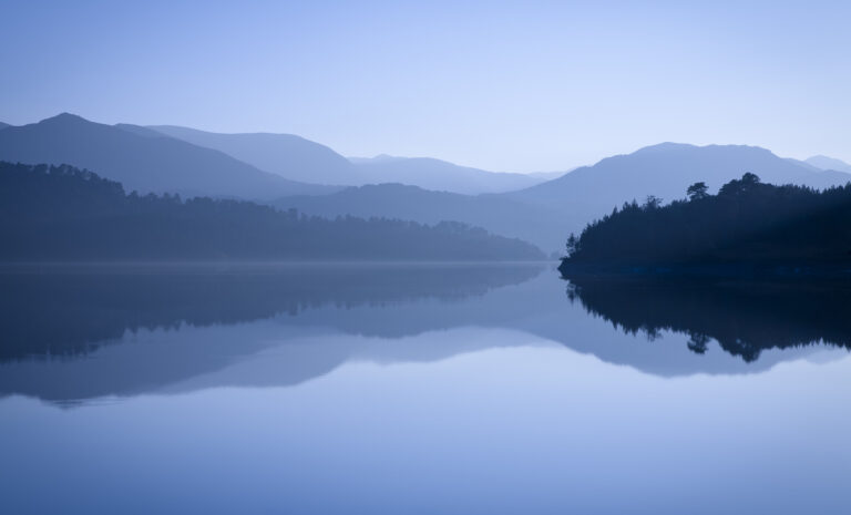 Mountains reflected in blue lake